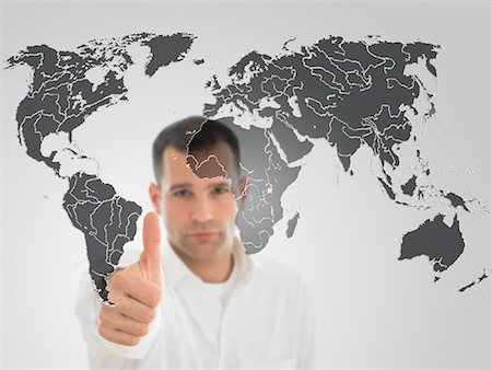 Portrait of Man Giving Thumbs Up in Front of World Map Stock Photo - Premium Royalty-Free, Code: 600-02123763