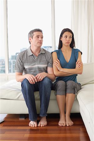 sulking arms folded - Couple on Sofa in Condominium Stock Photo - Premium Royalty-Free, Code: 600-02130681
