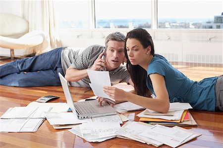 Couple with Bills and Laptop Computer Stock Photo - Premium Royalty-Free, Code: 600-02130690