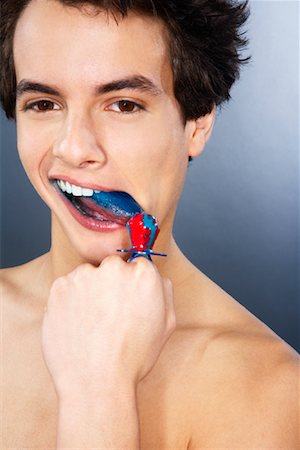 pic of 18 year boy in brown hair - Portrait of Man Eating Candy Stock Photo - Premium Royalty-Free, Code: 600-02200146