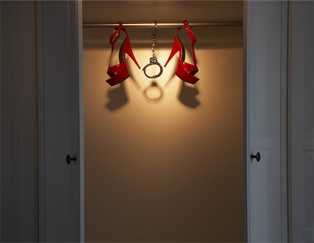 shoe hanging - Still Life of Red Shoes and Handcuffs in Closet Stock Photo - Premium Royalty-Free, Code: 600-02200688