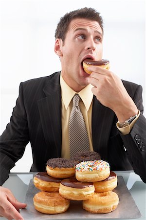 Man Eating Doughnuts Foto de stock - Sin royalties Premium, Código: 600-02201163