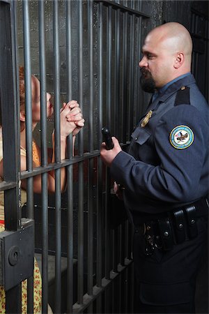 people inside jail cell - Woman Talking to Prison Guard Stock Photo - Premium Royalty-Free, Code: 600-02201335