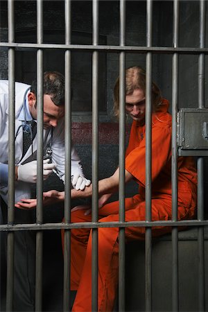 Doctor Giving Prisoner Injection Stock Photo - Premium Royalty-Free, Code: 600-02201365