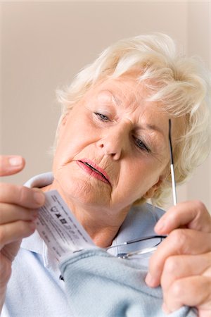 Woman Reading Laundry Instructions Stock Photo - Premium Royalty-Free, Code: 600-02244871