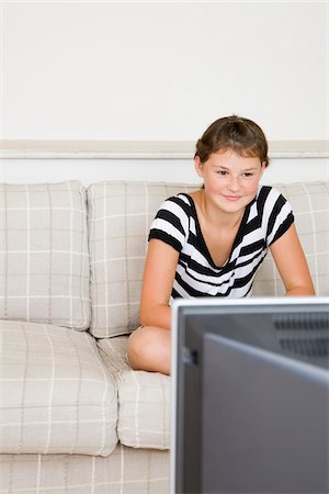 Teenaged Girl Watching Television Stock Photo - Premium Royalty-Free, Code: 600-02245075