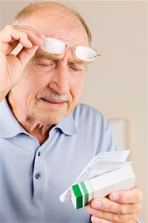Man Reading Instructions for Medicine Stock Photo - Premium Royalty-Free, Code: 600-02245223