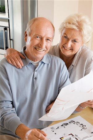 discussing kitchen design - Couple Looking at Floor Plans Stock Photo - Premium Royalty-Free, Code: 600-02257942