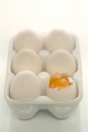 egg cracking - Broken Egg in Carton Stock Photo - Premium Royalty-Free, Code: 600-02264016