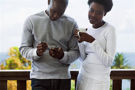 phone in front of face - Couple Drinking Coffee on Balcony Stock Photo - Premium Royalty-Free, Code: 600-02264543