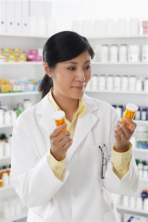 simsearch:600-02265323,k - Portrait of Pharmacist Holding Pill Bottles Stock Photo - Premium Royalty-Free, Code: 600-02265323