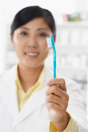 simsearch:600-02265323,k - Pharmacist Holding a Toothbrush Stock Photo - Premium Royalty-Free, Code: 600-02265332