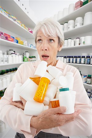 Client Holding Too Many Bottles of Pills Stock Photo - Premium Royalty-Free, Code: 600-02265354