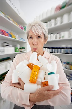 simsearch:600-02265499,k - Woman in Pharmacy with Armful of Medicine Stock Photo - Premium Royalty-Free, Code: 600-02265456