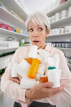 simsearch:600-02265499,k - Woman in Pharmacy with Armful of Medicine Stock Photo - Premium Royalty-Free, Code: 600-02265457