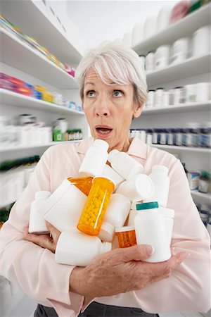 simsearch:600-02265499,k - Woman in Pharmacy with Armful of Medicine Stock Photo - Premium Royalty-Free, Code: 600-02265458