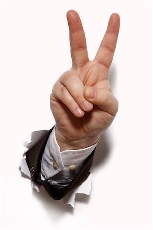 símbolo de paz - Businessman's Hand Bursting Through a Wall, Giving Peace Sign Foto de stock - Royalty Free Premium, Número: 600-02289262