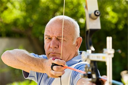 Man Using Bow and Arrow Stock Photo - Premium Royalty-Free, Code: 600-02290065