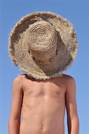 Boy with Straw Hat over Face Stock Photo - Premium Royalty-Free, Code: 600-02290109