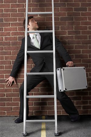 Businessman Walking Under Ladder Stock Photo - Premium Royalty-Free, Code: 600-02312380