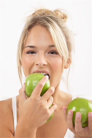 Young Woman Eating Apples Stock Photo - Premium Royalty-Free, Code: 600-02312475