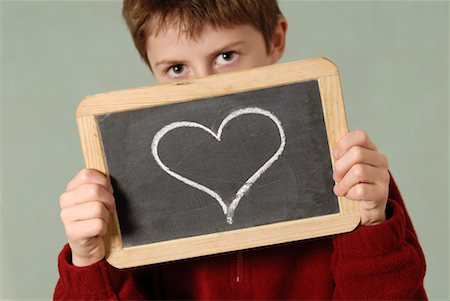 school boy symbol - Boy Holding Chalkboard with Heart Drawn on It Stock Photo - Premium Royalty-Free, Code: 600-02346183