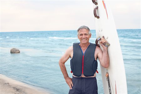 elderly women swimsuit - Portrait of Man Holding Windsurfer Board Stock Photo - Premium Royalty-Free, Code: 600-02346305