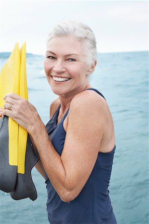 elderly woman fun outdoors - Portrait of Woman Wading in Water Stock Photo - Premium Royalty-Free, Code: 600-02346302