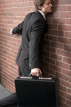 Businessman Walking into Brick Wall Stock Photo - Premium Royalty-Free, Code: 600-02346319