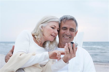 senior couple romantic beach lifestyle - Couple with Digital Camera Stock Photo - Premium Royalty-Free, Code: 600-02346338