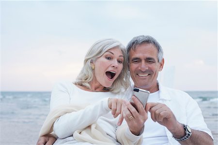 senior couple romantic beach lifestyle - Couple with Digital Camera Stock Photo - Premium Royalty-Free, Code: 600-02346339