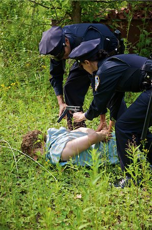 policewomen arrest - Police Officers Arresting Suspect Stock Photo - Premium Royalty-Free, Code: 600-02348032