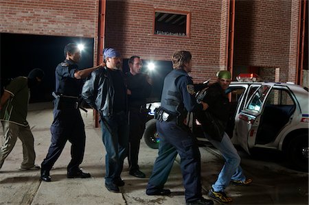 Police Officers Arresting Suspects Stock Photo - Premium Royalty-Free, Code: 600-02348109