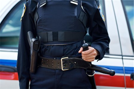 fondina - Close-up of Police Officer's Gun and Night Stick Fotografie stock - Premium Royalty-Free, Codice: 600-02348118