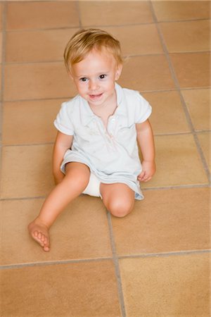 Little Boy Sitting on the Floor Stock Photo - Premium Royalty-Free, Code: 600-02348919