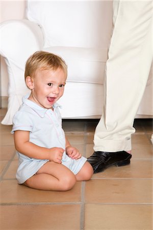 dad and baby laughing - Little Boy Sitting on the Floor Stock Photo - Premium Royalty-Free, Code: 600-02348910