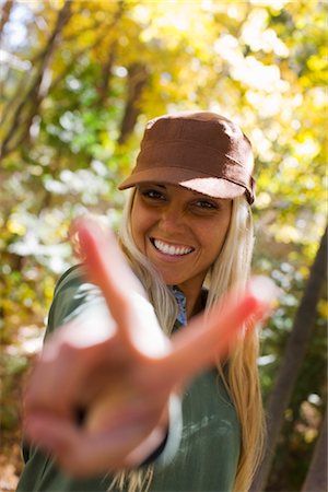 foreshortening - Portrait of Woman Making Peace Sign Stock Photo - Premium Royalty-Free, Code: 600-02386128