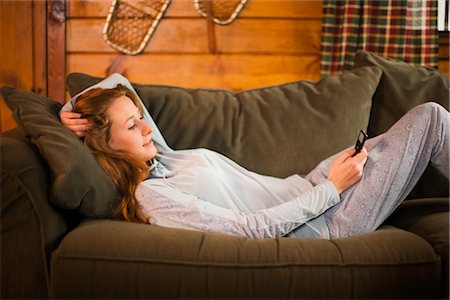 Woman Relaxing on Couch, Listening to MP3 Player Stock Photo - Premium Royalty-Free, Code: 600-02386175