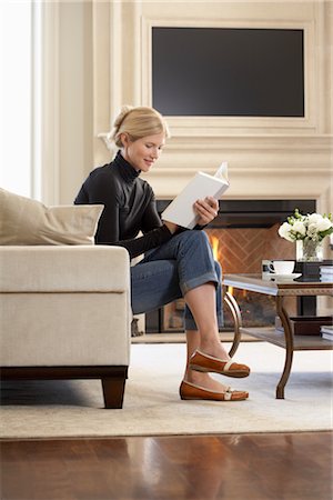 Woman Reading Book in Living Room Stock Photo - Premium Royalty-Free, Code: 600-02428891