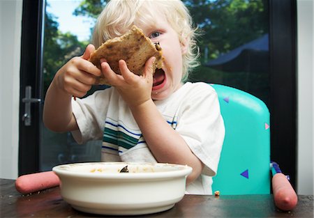 Little Boy Eating Pizza Stock Photo - Premium Royalty-Free, Code: 600-02429145