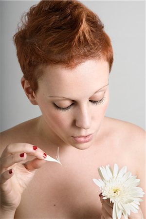 Portrait of Woman Plucking a Flower Stock Photo - Premium Royalty-Free, Code: 600-02504716