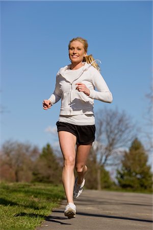 running and young and fit and woman and outdoors - Woman Jogging Stock Photo - Premium Royalty-Free, Code: 600-02594278