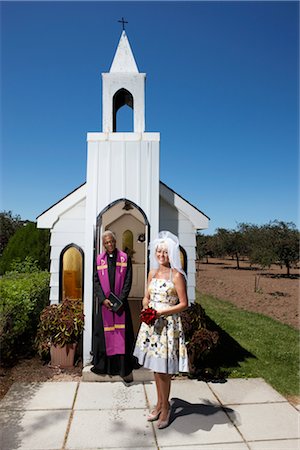 Bride and Priest Standing in Front of Church, Niagara Falls, Ontario, Canada Stock Photo - Premium Royalty-Free, Code: 600-02593701