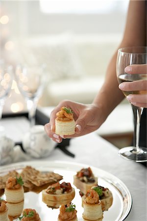 starter - Woman Taking a Shrimp Puff Pasty Hors d'Oeuvre From a Tray Stock Photo - Premium Royalty-Free, Code: 600-02637879