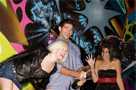 sparkling wine - Friends Popping Champagne Bottle, Los Angeles, California, USA Stock Photo - Premium Royalty-Free, Code: 600-02637977