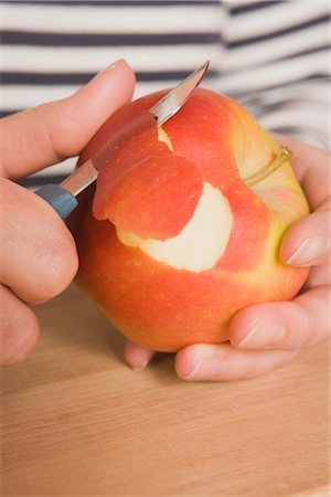 Hands Peeling Apple Stock Photo - Premium Royalty-Free, Code: 600-02638211