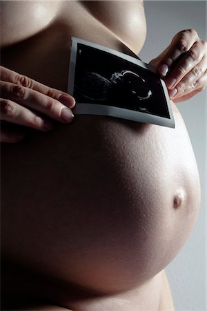 female fetus - Pregnant Woman with Ultrasound Photograph of Baby Stock Photo - Premium Royalty-Free, Code: 600-02660030
