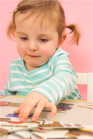 Little Girl Doing a Puzzle Stock Photo - Premium Royalty-Free, Code: 600-02660146