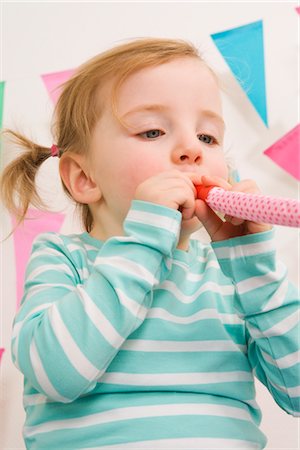 simsearch:600-02660154,k - Little Girl Blowing a Noisemaker at a Birthday Party Stock Photo - Premium Royalty-Free, Code: 600-02660148