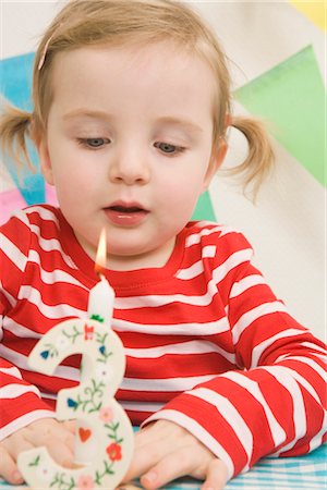 Little Girl Blowing Out Candle at a Birthday Party Stock Photo - Premium Royalty-Free, Code: 600-02660155